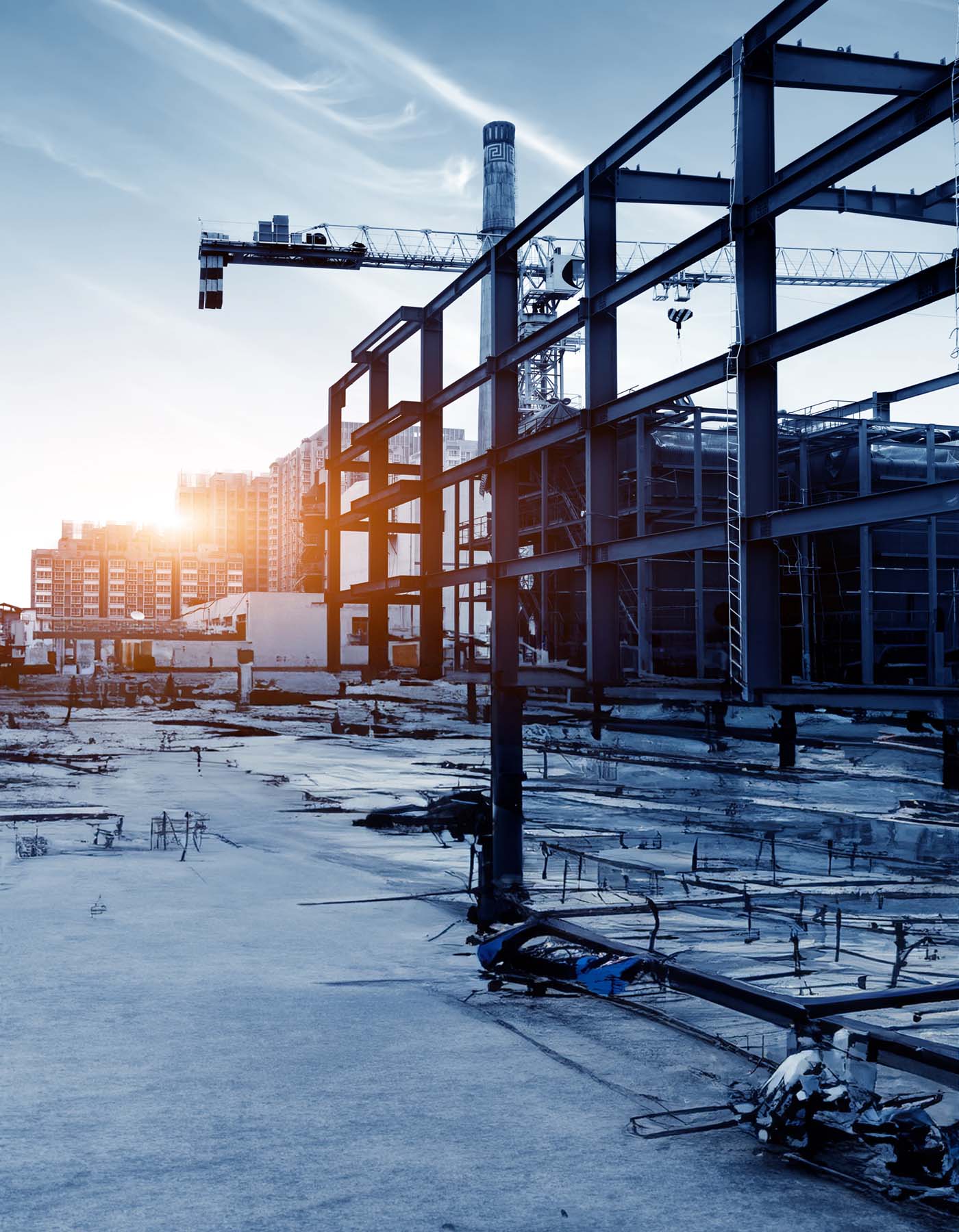 Construction site, silhouettes of construction industry workers on scaffolding against the sunset light.