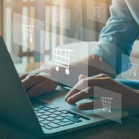 Kuvassa käyttäjä kannettavalla tietokoneella ja ilmassa leijailee ostoskärryn kuvia